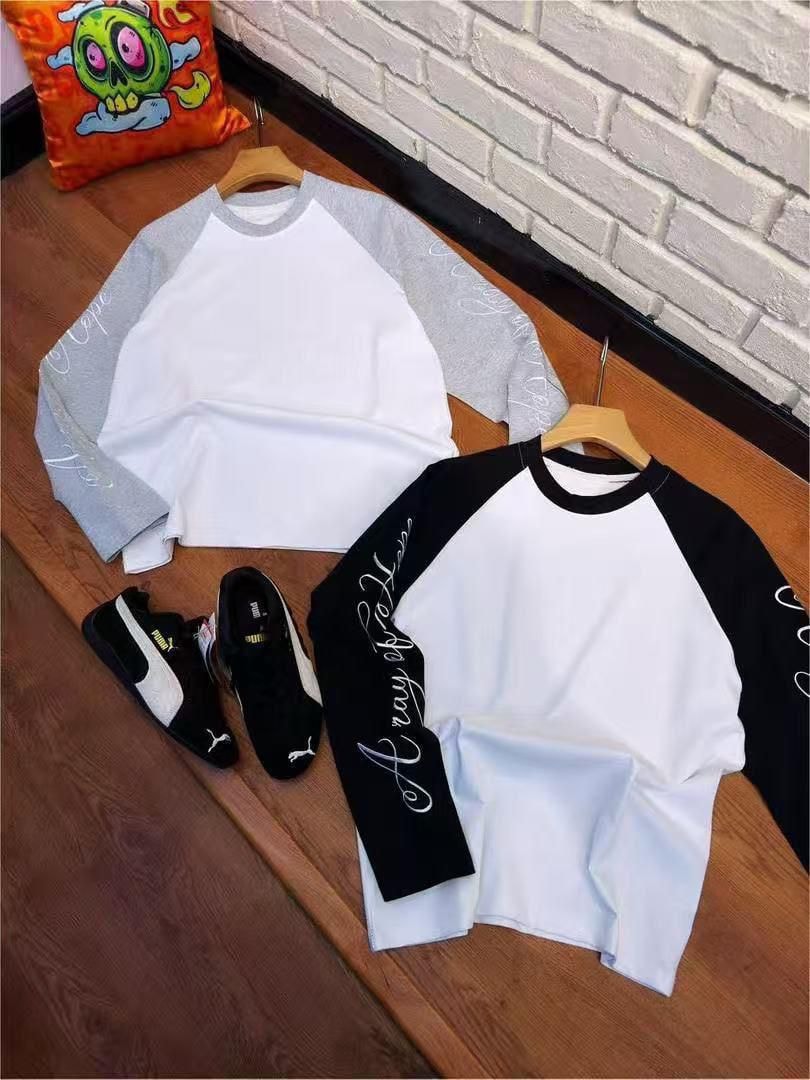 Gray and black sleeve Cape raglan long sleeve tees flat lay styled with Puma sneakers.